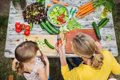 mother and daughter preparing salad - food stock pictures, royalty-free photos & images