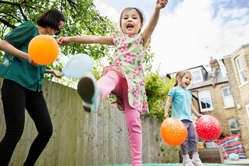 mother and daughters playing in garden with balloons - garden decoration stock pictures, royalty-free photos & images