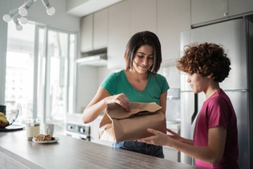 mother and son opening takeaway food at home - junk food stock pictures, royalty-free photos & images