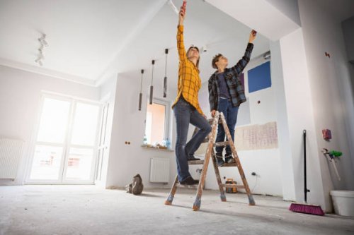 mother and son painting wall at home - home decoration stock pictures, royalty-free photos & images