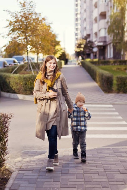 mother and son walking city street - junk food stock pictures, royalty-free photos & images