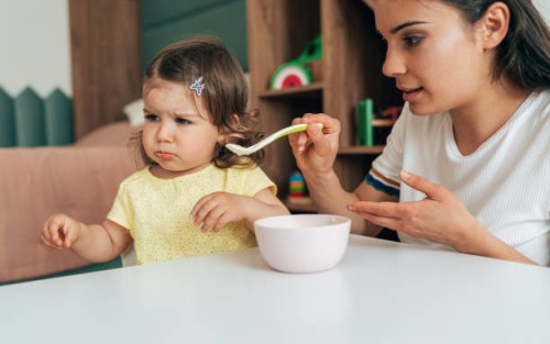 mother feeding her girl - food stock pictures, royalty-free photos & images