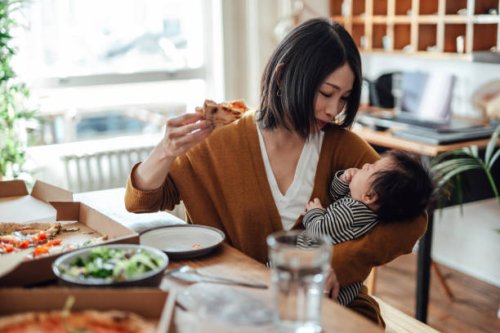 mother having pizza for lunch while playing with her baby at home - junk food stock pictures, royalty-free photos & images