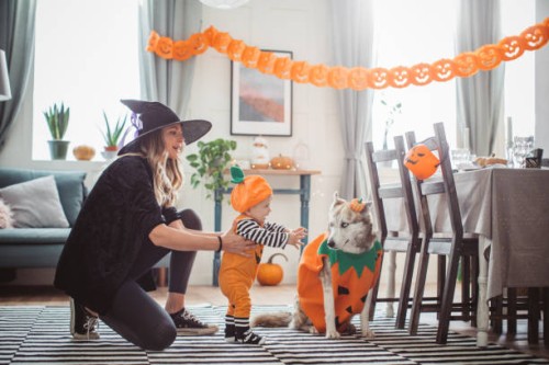 mother helping baby to walk on halloween - home decoration stock pictures, royalty-free photos & images