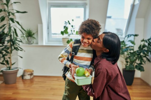 mother kissing her son who is going to school - food stock pictures, royalty-free photos & images