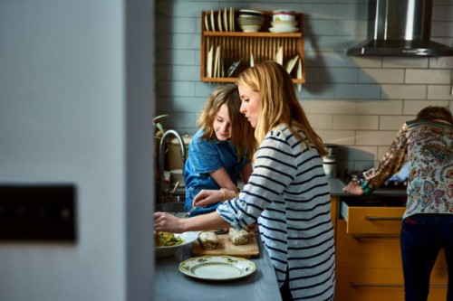 mother serving lunch with daughter in kitchen - food stock pictures, royalty-free photos & images