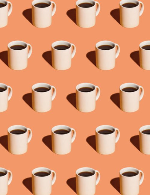 mugs of black coffee in rows against peach background - coffee stock pictures, royalty-free photos & images