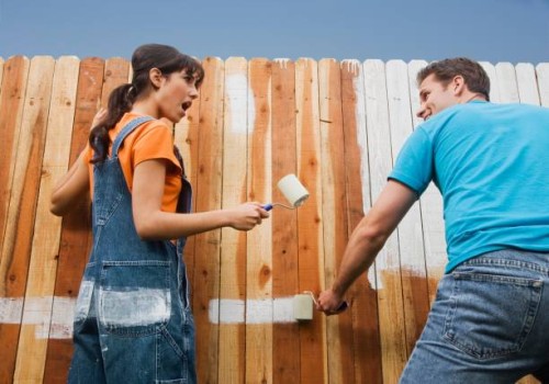 multi-ethnic couple painting fence - garden decoration stock pictures, royalty-free photos & images