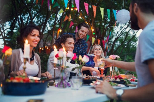 multi-ethnic friends enjoying meal in back yard at garden party - garden decoration stock pictures, royalty-free photos & images