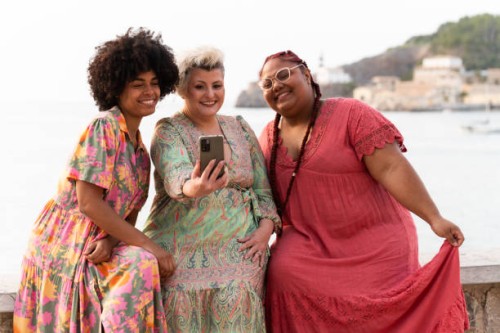multi-ethnic friends taking a selfie smiling next to the sea - fashion stock pictures, royalty-free photos & images