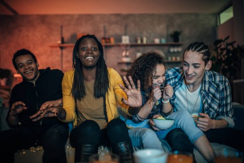 multi-ethnic friends watching tv - junk food stock pictures, royalty-free photos & images