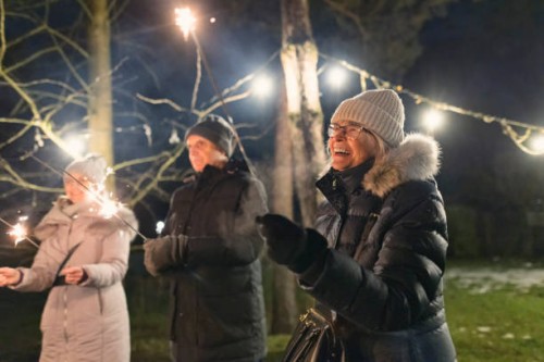 multi-generation family enjoying sparklers in the backyard on christmas eve - garden decoration stock pictures, royalty-free photos & images