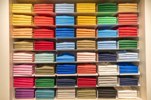 multi coloured polo shirts on eight shelves stacked in a store, spain - fashion stock pictures, royalty-free photos & images