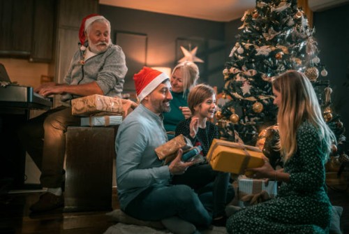 multigeneration family on the living room exchancing christmas presents - home decoration stock pictures, royalty-free photos & images