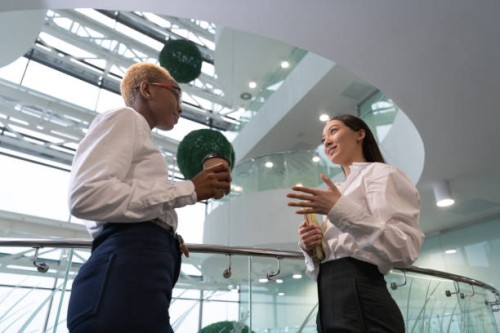 multiracial businesswomen talking during break - junk food stock pictures, royalty-free photos & images