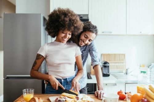 multiracial family in kitchen expressing love and happiness - food stock pictures, royalty-free photos & images
