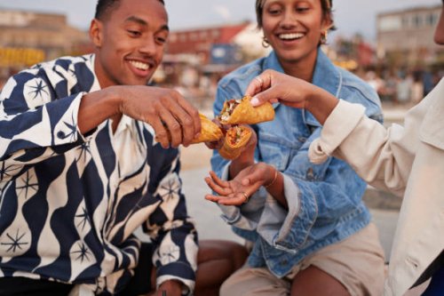 multiracial friends toasting tacos on promenade - food stock pictures, royalty-free photos & images