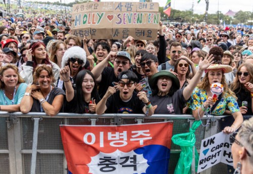 Music fans wait to see K-Pop group Seventeen perform on the Pyramid Stage during day three of Glastonbury Festival 2024 at Worthy Farm, Pilton on...