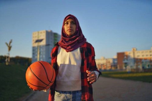 muslim young woman outdoors in the city, with basketball. - fashion stock pictures, royalty-free photos & images