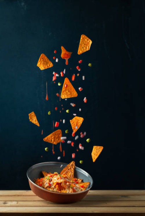 nachos levitating against black background,vadodara,gujarat,india - food stock pictures, royalty-free photos & images