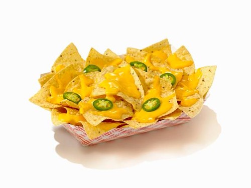 nachos with cheese sauce and sliced jalapenos in a take out container - junk food stock pictures, royalty-free photos & images