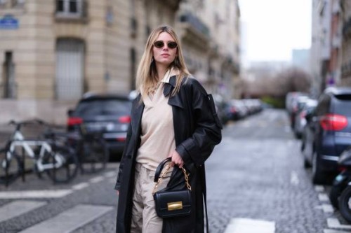 Natalia Verza wears parachute cargo pants in gray by Munthe, a layering sweater by Gerard Darel, a shirt by Munthe, a black oversized leather biker...