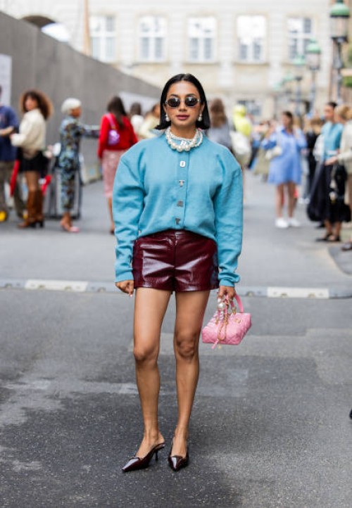 Navdeep Kaur wears blue oversized jacket, burgundy shorts, pink Chanel bag, sunglasses, pearl necklace outside Rotate during day four of the...