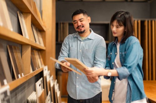 new home choices.couple at a furniture or material store looking at different options on the retail display . - home decoration stock pictures, royalty-free photos & images
