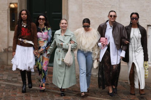 Nicole Huisman seen wearing brown Ganni sunnies, gold hoop earrings, colorful pearl necklace, small rose colored Prada Cleo handbag, colorful printed...