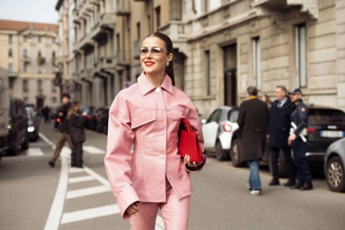 Nina Sandbech wears pink leather matching pants and jacket, red bag outside the Sportmax fashion show during the Milan Fashion Week Womenswear...