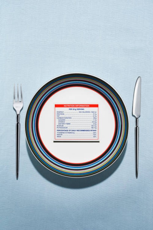 nutrition label on plate in table setting - junk food stock pictures, royalty-free photos & images