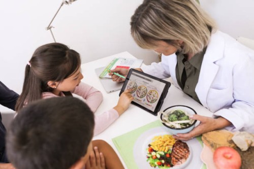 nutritionist and little patients with their mother during a medical consultation in the doctor's office - food stock pictures, royalty-free photos & images