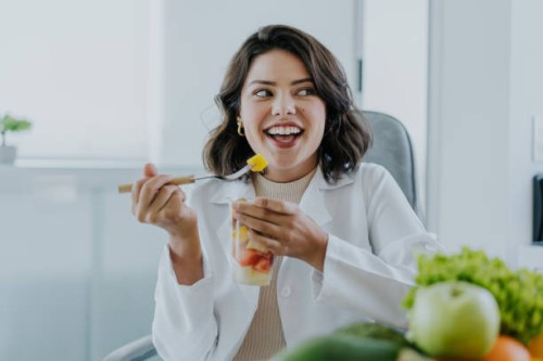 nutritionist eating fruit salad - food stock pictures, royalty-free photos & images
