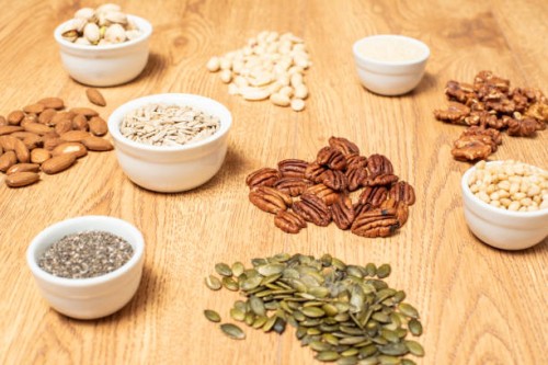 nuts and seeds on a table - food stock pictures, royalty-free photos & images