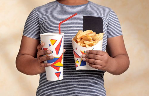 obese boy with snack - junk food stock pictures, royalty-free photos & images