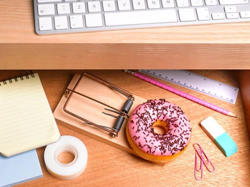 obesity issues doughnut hidden in desk drawer - junk food stockfoto's en -beelden