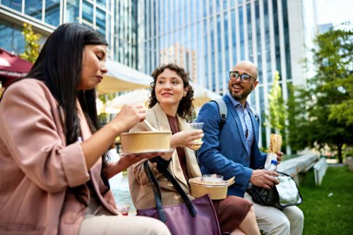 office workers eating lunch together - junk food stock pictures, royalty-free photos & images