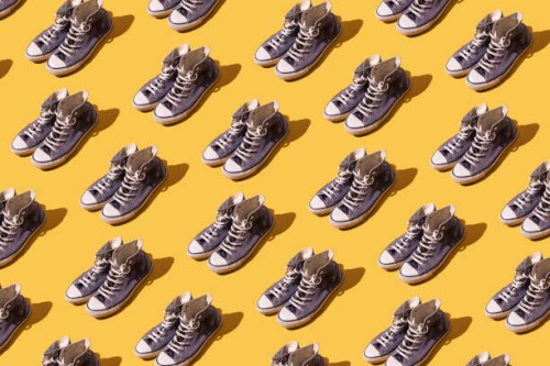 old style worn blue basketball shoe pattern on yellow background. fashion, modern, retro and casual footwear concept. - fashion photos et images de collection