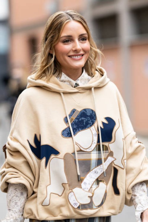 Olivia Palermo is seen wearing a white cream and black printed shirt and a beige hoodie embellished with patches on the front outside Antonio Marras...