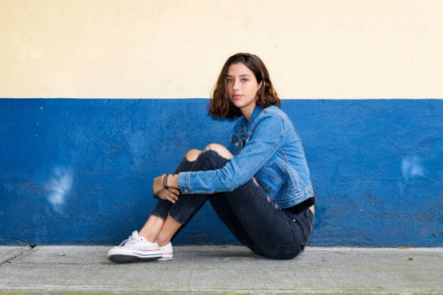 one hispanic teenage girl sitting on the floor in mexico city, mexico - fashion stock pictures, royalty-free photos & images
