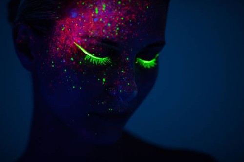 one woman painted with fluorescent make up - fashion stock pictures, royalty-free photos & images