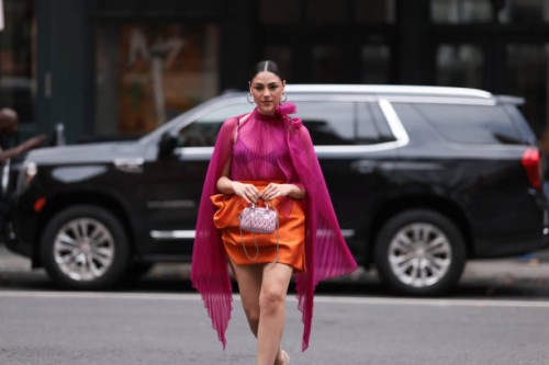 Oralia A. Villarreal Cantú was seen wearing a light pink Miu Miu bag, a black bra, a orange silk skirt, silver high heels and a transparent pink top...