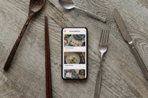 ordering food by mobile app delivery on smartphone - junk food stock pictures, royalty-free photos & images