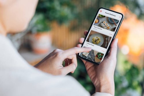 ordering food online at home with smartphone - junk food stock pictures, royalty-free photos & images