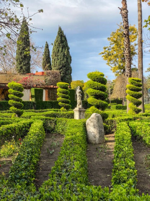 ornate plants and statue in the jardines del real in valencia, spain - garden decoration stock pictures, royalty-free photos & images