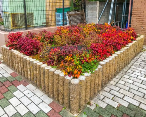 otafukunanten in flowerbed at a corner of the street - garden decoration stock pictures, royalty-free photos & images