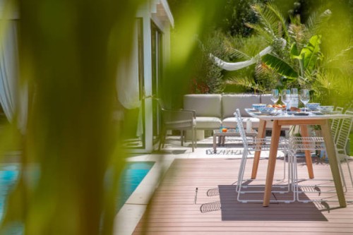 outdoor garden living space with dining table setting on wood terrace patio next to swimming pool - garden decoration stock pictures, royalty-free photos & images
