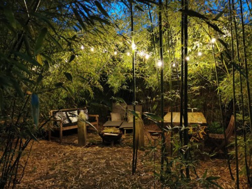 outdoor garden lounge under bamboo at night with a light garland - garden decoration stock pictures, royalty-free photos & images