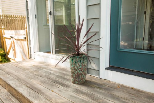 outdoor planter with potted plant on patio deck - garden decoration stock pictures, royalty-free photos & images