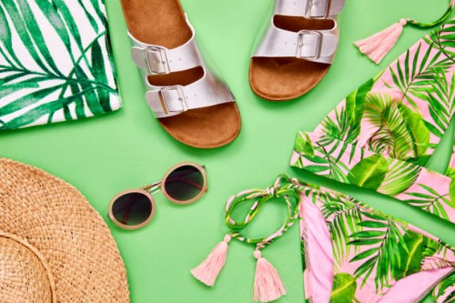 overhead shot of summer vacation accessories on green background - fashion stock pictures, royalty-free photos & images